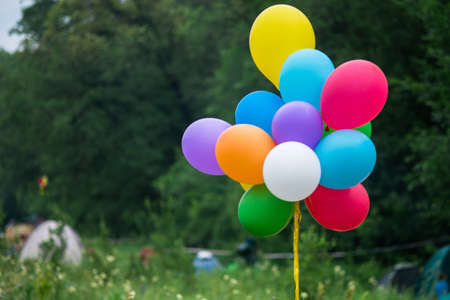 multicolored balloons tied to the yellow ropeの写真素材