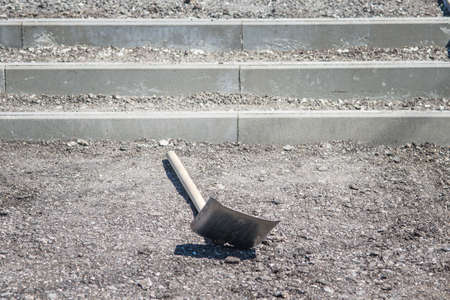 thrown shovel at the construction site under the bright sunの写真素材
