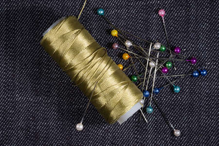 sewing accessories on the background of denim closeup
