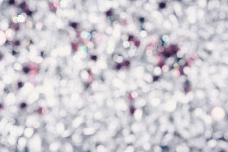 background of crumpled glossy metallic foil and rhinestones closeupの写真素材