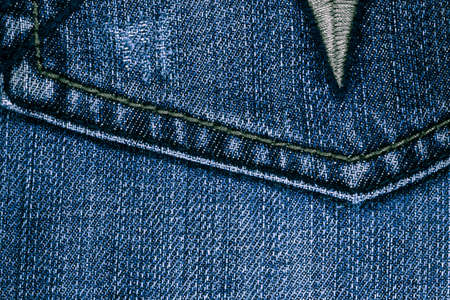 background of denim close-up finishes and decorative stitchingの写真素材