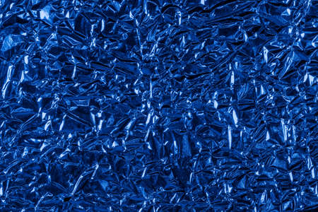background of crumpled glossy metallic foil closeup