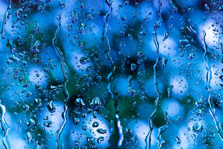 bright abstract background of water drops on glassの写真素材