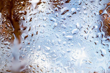 bright abstract background of water drops on glassの写真素材