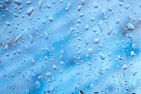 bright abstract background of water drops on glass