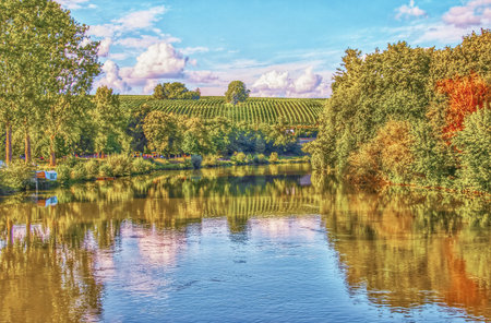 Serene Autumn River with Hills and Skyの写真素材