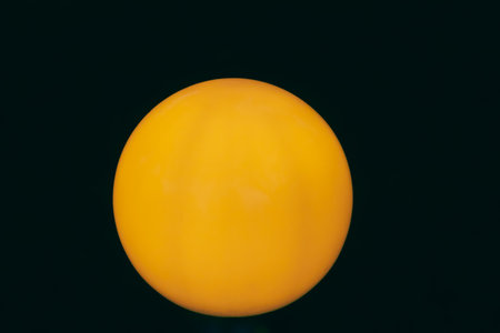 Bright Orange Sphere on Black Background with Smooth Gradient