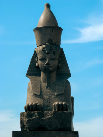 Ancient Egyptian Sphinx Statue with Nemes Headdress under Blue Sky