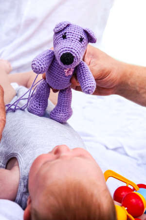 newborn baby with teddy bearの写真素材