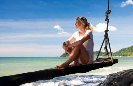 woman  looking into the distance  on the tropical beachの写真素材