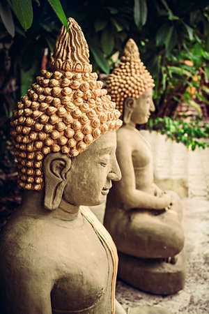 Sitting stone Buddha statues at temple areaの写真素材
