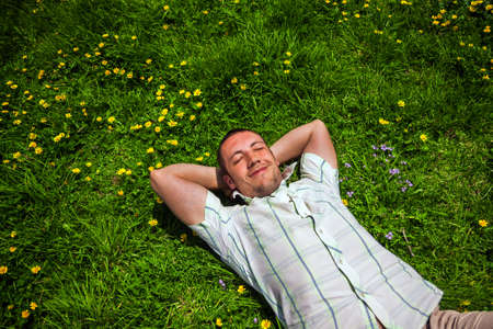 Man dreaming lying on the grassの写真素材