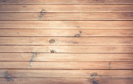 Whitish planked vintage wooden wall background with knotsの写真素材
