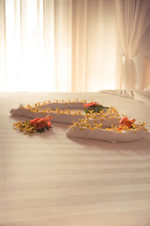 Luxury romantic hotel suite room for honeymoon couple with heart shape elements and flowersの写真素材