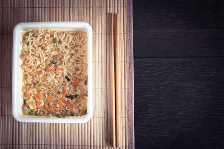 Traditional Chinese cuisine served in asian restaurant on wooden table with bamboo mat with copy spaceの写真素材