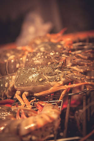 Seafood preparing on bbq grill in restaurant kitchen  with hot red charcoalの写真素材