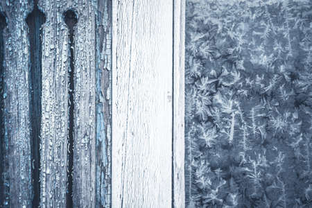 Winter background with frost pattern on rustic window with copy spaceの写真素材