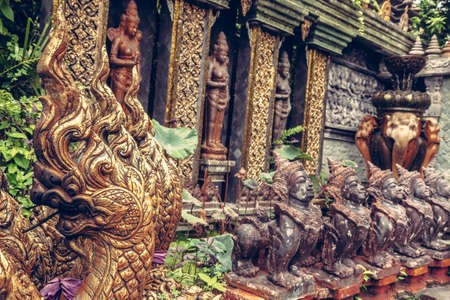 Asian style decorations in the tropical garden with deities and demons