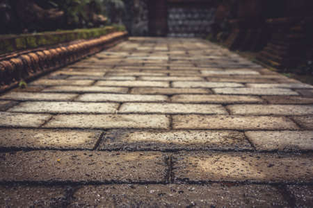 Ancient pavement leading into the distance with vanishing point as ancient background in vintage styleの写真素材