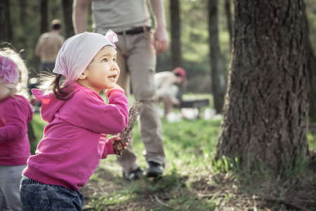 Playful child playing outdoors in summer forest during weekend holidaysの写真素材