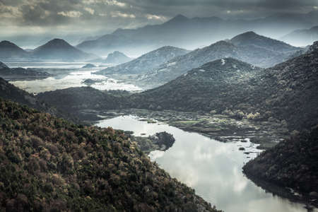 Mountains landscape with river creek around Rijeka Crnojevica river from high view in overcast day with dramatic sky in Europe country Montenegroの写真素材