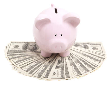 Pink piggy bank on dollars の写真素材