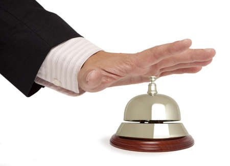 Hand of a businessman using a hotel bell isolated の写真素材