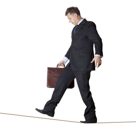 Businessman rope-walker  Isolated on white background の写真素材