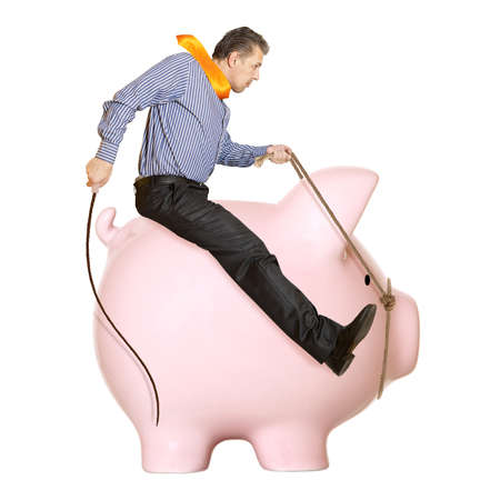 Businessman riding a piggy bank  Concept の写真素材