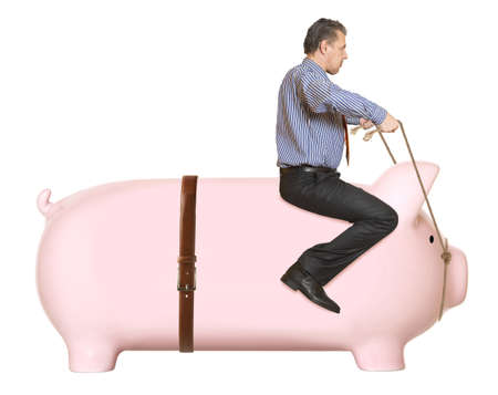 Businessman riding a piggy bank  Concept の写真素材