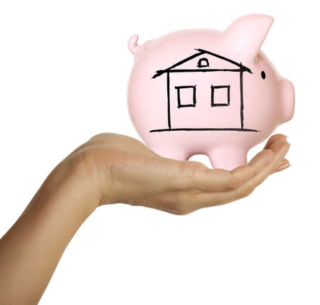 A woman hand holding a piggy bank  Isolated on white の写真素材