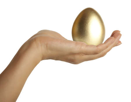 Golden egg in the hand の写真素材