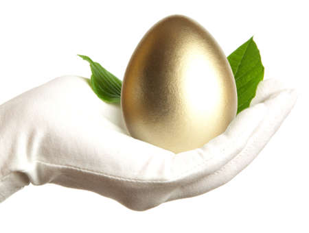 Golden egg in the hand の写真素材