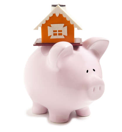 Piggy bank with small model house isolatedの写真素材