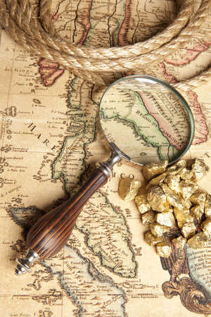 Magnifying glass, ancient old map and Gold Nugget の写真素材