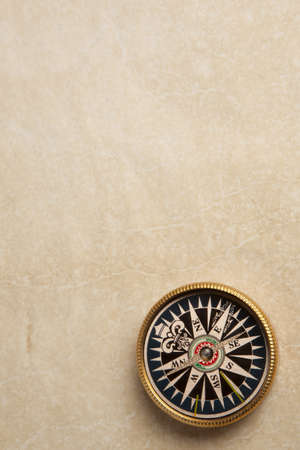 Close up view of compass on vintage paper の写真素材