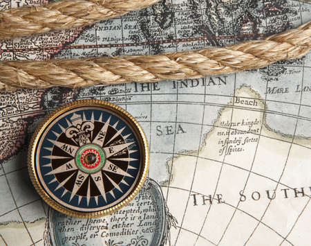 Old compass and rope on vintage mapの写真素材