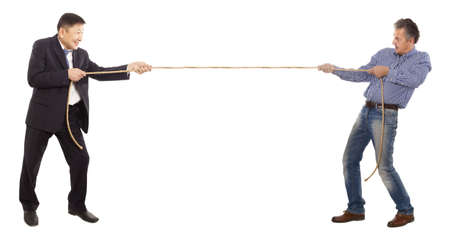Two adult businessman pull the ropeの写真素材