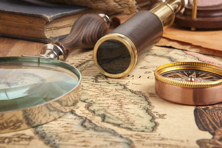 Vintage brass telescope on antique mapの写真素材