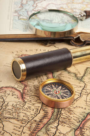 Vintage brass telescope on antique mapの写真素材