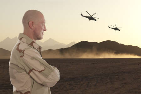 Marine amid the mountains of Afghanistan and helicoptersの写真素材