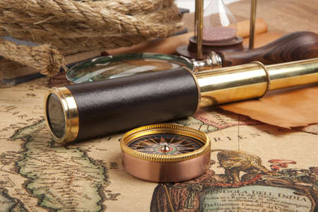 Vintage brass telescope on antique mapの写真素材