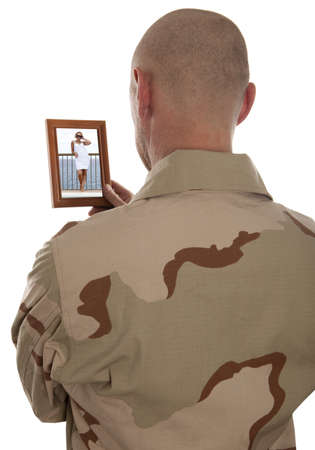 Conscript  marine looks at the photo of the girlfriend isolated over a white backgroundの写真素材