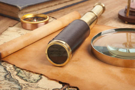 Vintage brass telescope on antique mapの写真素材