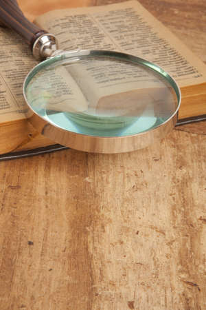 Magnifying glass and old vintage bookの写真素材