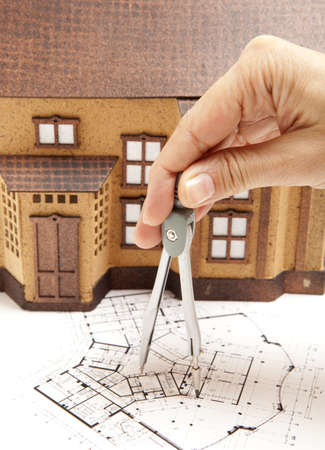 Female architect hand and house modelの写真素材