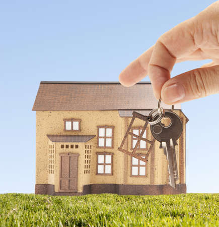 Handing keys in the house sky background  の写真素材