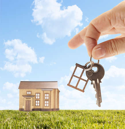 Handing keys in the house sky background  の写真素材