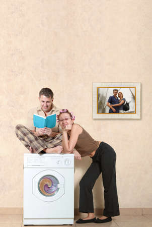Ideal family washing clothes in a washing machineの写真素材