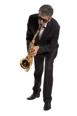 Full length portrait of a man playing on saxophone isolated on background の写真素材